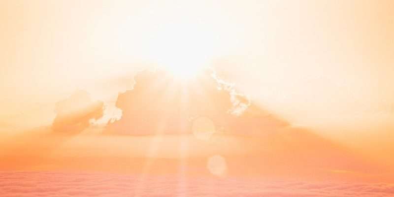 sun rays over clouds and mountains