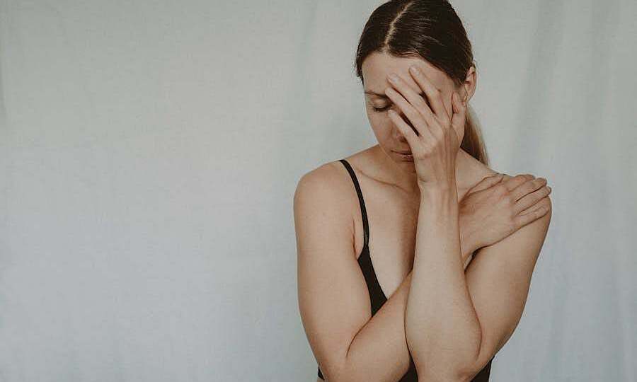 Young sad woman with closed eyes