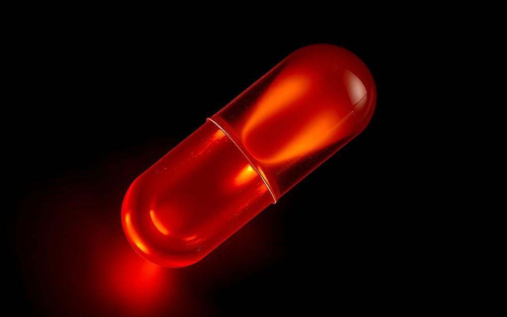 A high-contrast macro photograph of a glowing red-orange capsule filled with a rich, golden liquid against a stark black background. The capsule is highlighted by soft, directional lighting, casting intricate shadows that reveal its detailed texture and form. The liquid inside appears to shimmer and radiate a warm, amber glow, suggesting its potent anti-inflammatory properties. The overall composition emphasizes the capsule's central role as a concentrated source of the antioxidant resveratrol, visually communicating its scientific significance in the context of inflammation and health.