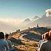 A serene, ethereal landscape showcasing the harmony of spiritual communities. In the foreground, a group of people gathered in meditation, their faces radiant with inner peace. The middle ground reveals a winding path leading to a secluded sanctuary, its architecture blending seamlessly with the natural surroundings. In the background, majestic mountains rise, their peaks kissed by wisps of clouds, conveying a sense of timelessness and connection to the divine. Soft, diffused lighting filters through the scene, creating a warm, contemplative atmosphere. The overall composition evokes a sense of unity, contemplation, and the pursuit of higher consciousness.