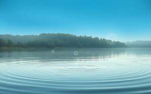 A serene, ethereal landscape depicting the intricate connection between water and consciousness. In the foreground, a tranquil pond reflects the sky above, its surface rippling with a subtle, hypnotic pattern. Floating amidst the water, glowing orbs of energy represent the conscious awareness that permeates the element. In the middle ground, a lush, verdant forest frames the scene, suggesting the natural harmony between water, life, and the unseen forces of the mind. The background is a soft, dreamlike gradient of blues and greens, evoking a sense of transcendent, holistic understanding. The lighting is soft and diffused, creating a sense of warmth and mysticism. The overall composition and atmosphere invite the viewer to contemplate the profound interconnectedness of water, health, and the depths of human consciousness.